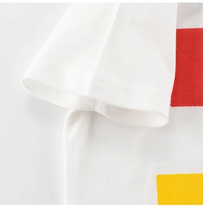 Close-up of boys white cotton t-shirt sleeve with precise double-needle stitching detail