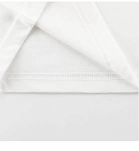 Close-up of high-quality stitching and cotton knit texture on boys' white t-shirt hem