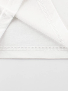 Close-up of white cotton t-shirt hem with professional double-needle stitching detail