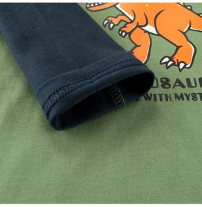Close-up of durable double-needle stitching on green and navy dinosaur long sleeve shirt
