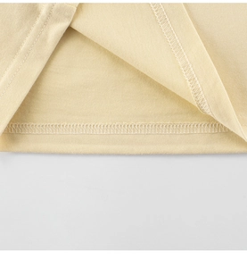 Close-up of boys' dinosaur t-shirt hem showing high-quality flatlock stitching detail