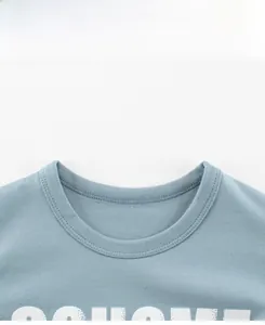 Detail view of light blue crew neck cotton shirt with white lettering and double stitching