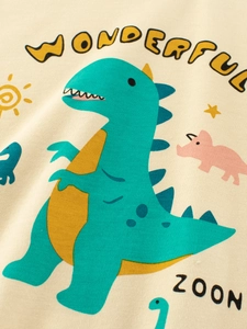 Boys long sleeve t-shirt featuring colorful cartoon dinosaur prints on cream knit fabric