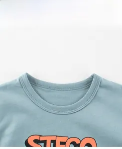 Detail of ribbed crew neck with double stitching and STEGO print on blue cotton T-shirt