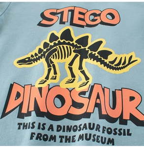 Detail showing the dinosaur fossil print on light blue cotton long-sleeved kids' T-shirt