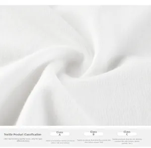 Macro detail of white cotton knit fabric texture with safety classification info