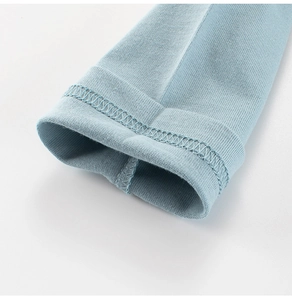 Detail of light blue cotton sleeve cuff with professional double-needle stitching on kids shirt