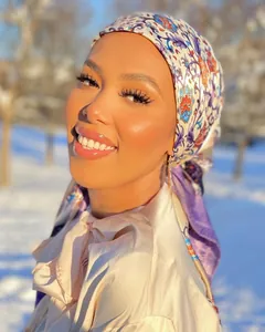 Outdoor close-up of a floral satin hijab for women in golden sunset scenery