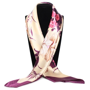 Detail of silk scarf showing ink-wash floral print and glossy fabric on neck display