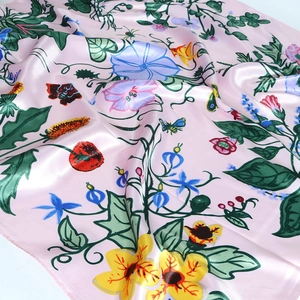 Pink floral satin scarf with sunflower and butterfly prints in a premium soft silk drape