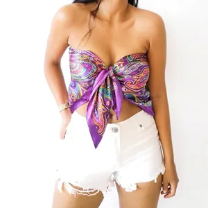 Bohemian paisley print silk scarf worn as a bandeau top with front knot and denim shorts