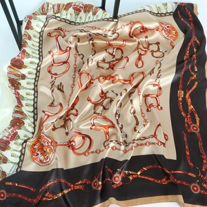 Classic equestrian chain print satin silk scarf with champagne gold and black border motif