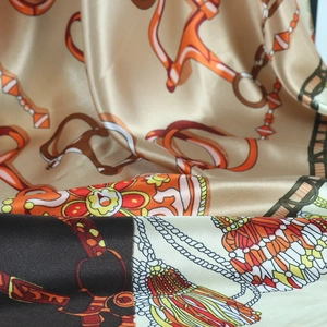 Detailed close-up of retro chain print satin scarf with luxury equestrian patterns