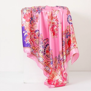 Detail of pink paisley floral silk scarf showing premium fabric texture and drape
