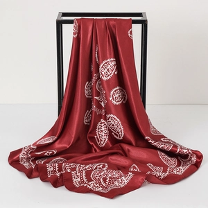 Detail of red and white paisley silk scarf showing smooth texture and elegant drape