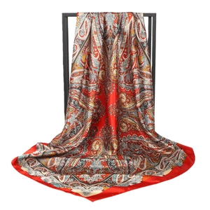 Red paisley print silk scarf with vintage court style on minimalist display stand