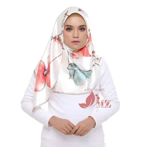 Detail of the elegant satin floral headscarf with large red flowers on beige background