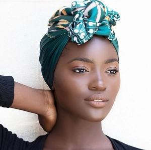 Detail of satin chain print scarf tied as a luxury headwrap on fashion model