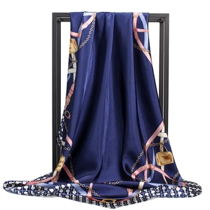 Elegant navy blue silk-like square scarf with gold chain and strap patterns