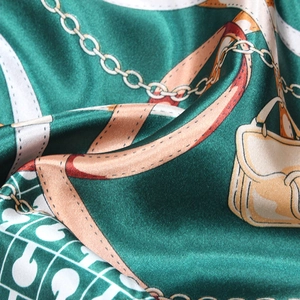 Luxurious satin silk scarf with vintage gold chain and leather handbag print pattern