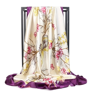 Detail view of floral satin silk square scarf with purple hem and butterfly print