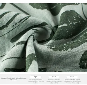 Close-up of soft ribbed cotton fabric with leaf pattern and textile safety label