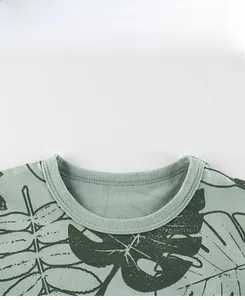 Detail view of cotton t-shirt ribbed neckline with tropical leaf print and fine stitching