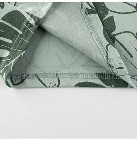 Detail of light green tropical leaf print T-shirt with high-quality double-needle hem