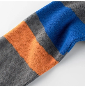 Close-up of striped knit fabric detail showing grey orange and blue textured cotton weave