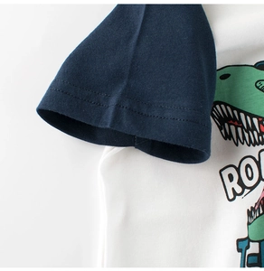 Detail of boys cotton T-shirt featuring navy sleeves and dinosaur print with ROAR text
