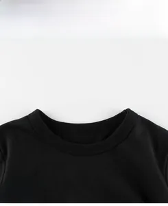 Close-up of black cotton t-shirt with ribbed crew neck and colorful cartoon prints