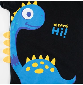 Close-up of a blue cartoon dinosaur print and 'means Hi!' text on a black cotton kids T-shirt