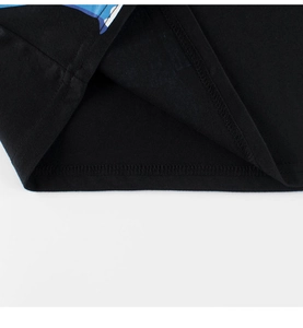 Detail of double-needle stitching on black cotton T-shirt hem with blue graphic print