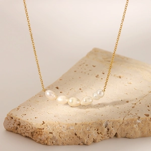 Elegant gold-plated stainless steel necklace with five white freshwater pearls on stone