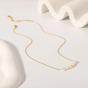 Elegant gold stainless steel necklace featuring five graduated freshwater pearls on O-chain