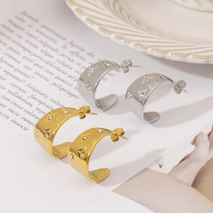 Elegant gold and silver U-shaped hoop earrings with sparkling rhinestones and star engraving