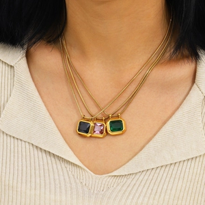 Three-layer gold snake chain necklace with black, pink, and green zircon pendants