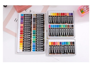 Artistic layout of heavy-color oil pastels set with colorful wax sticks and cute props