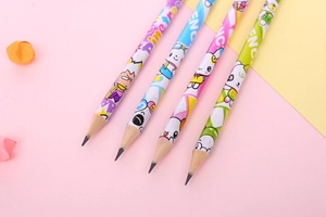 Close-up of four HB wooden pencils with colorful cartoon patterns and graphite nibs