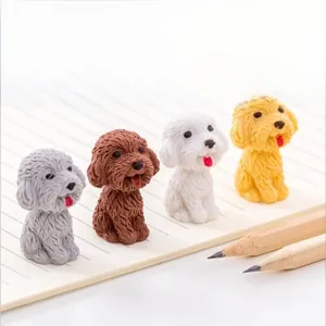 Close-up of four cute dog-shaped erasers in various colors on a lined notebook