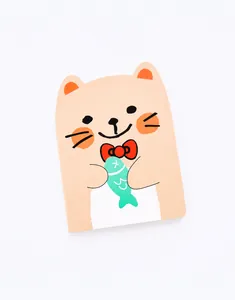 Detailed view of a cute cartoon cat notebook with matte paper texture and rounded edges