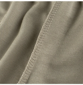 Close-up of fine stitching and soft khaki fabric texture on summer mosquito pants