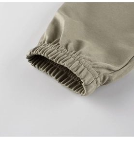 Detail of elastic cuff on olive green kids' anti-mosquito pants with fine woven texture