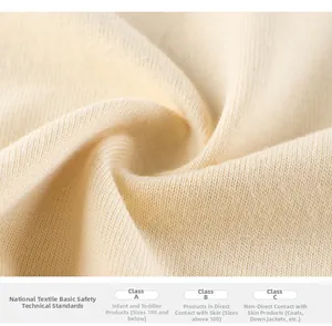 Detailed macro view of soft cream ribbed fabric texture showing high safety standards