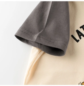 Close-up of raglan sleeve stitching and printed cotton fabric on kids summer t-shirt