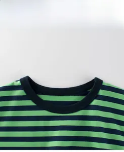 Detail of the navy rib crew neck and horizontal green stripes on a cotton t-shirt