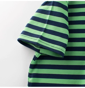Detail view of stitched sleeves and green navy striped pattern on cotton T-shirt