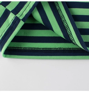 Detail of green and black striped cotton t-shirt showing double-stitched hem finish