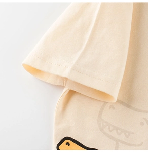 Close-up of double-stitched sleeve cuff and cute cartoon dinosaur print on cotton tee