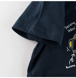 Detail of double-needle stitching on navy cotton sleeve with excavator graphic print